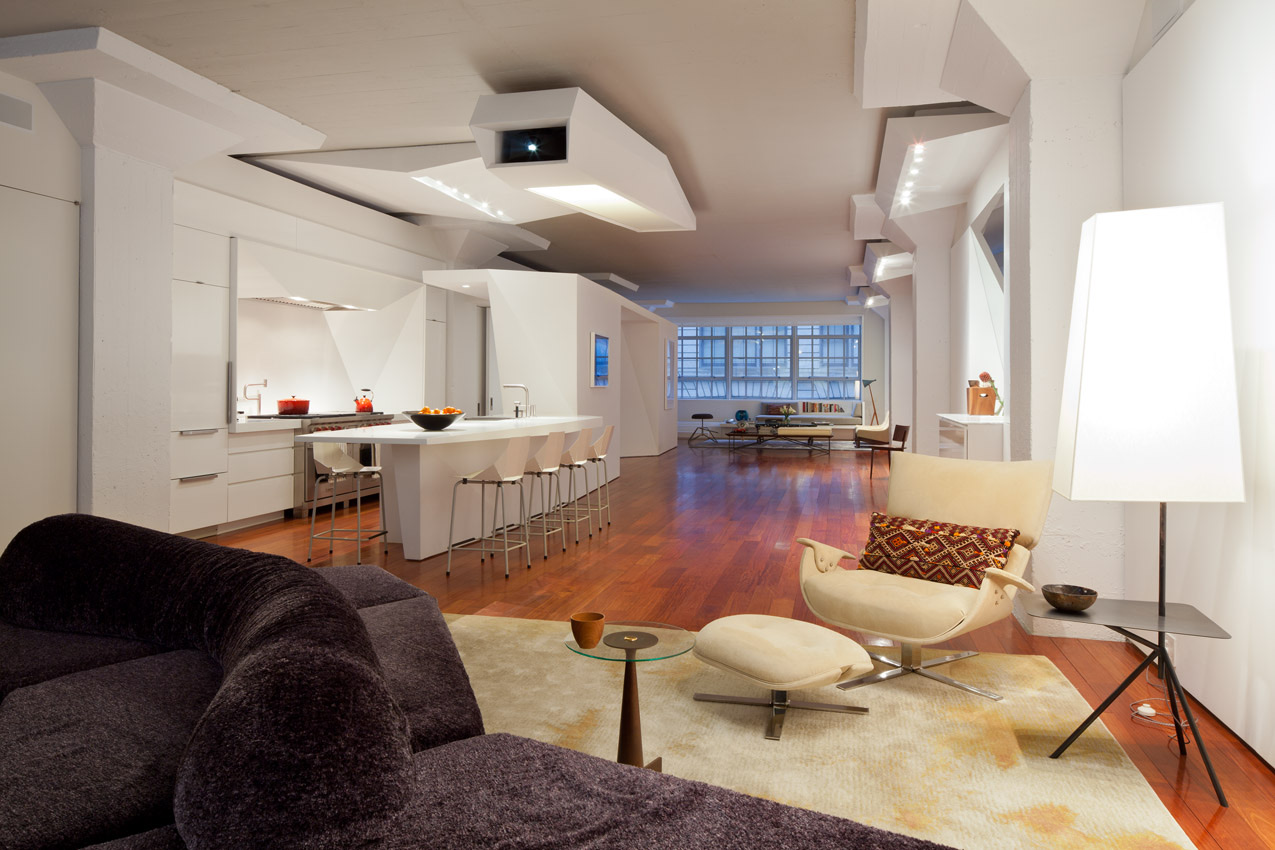 Tribeca bachelor's loft with sculptural white ceiling, open kitchen and warm wood floors